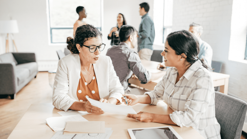 2 executives discussing strategy in a conference room setting